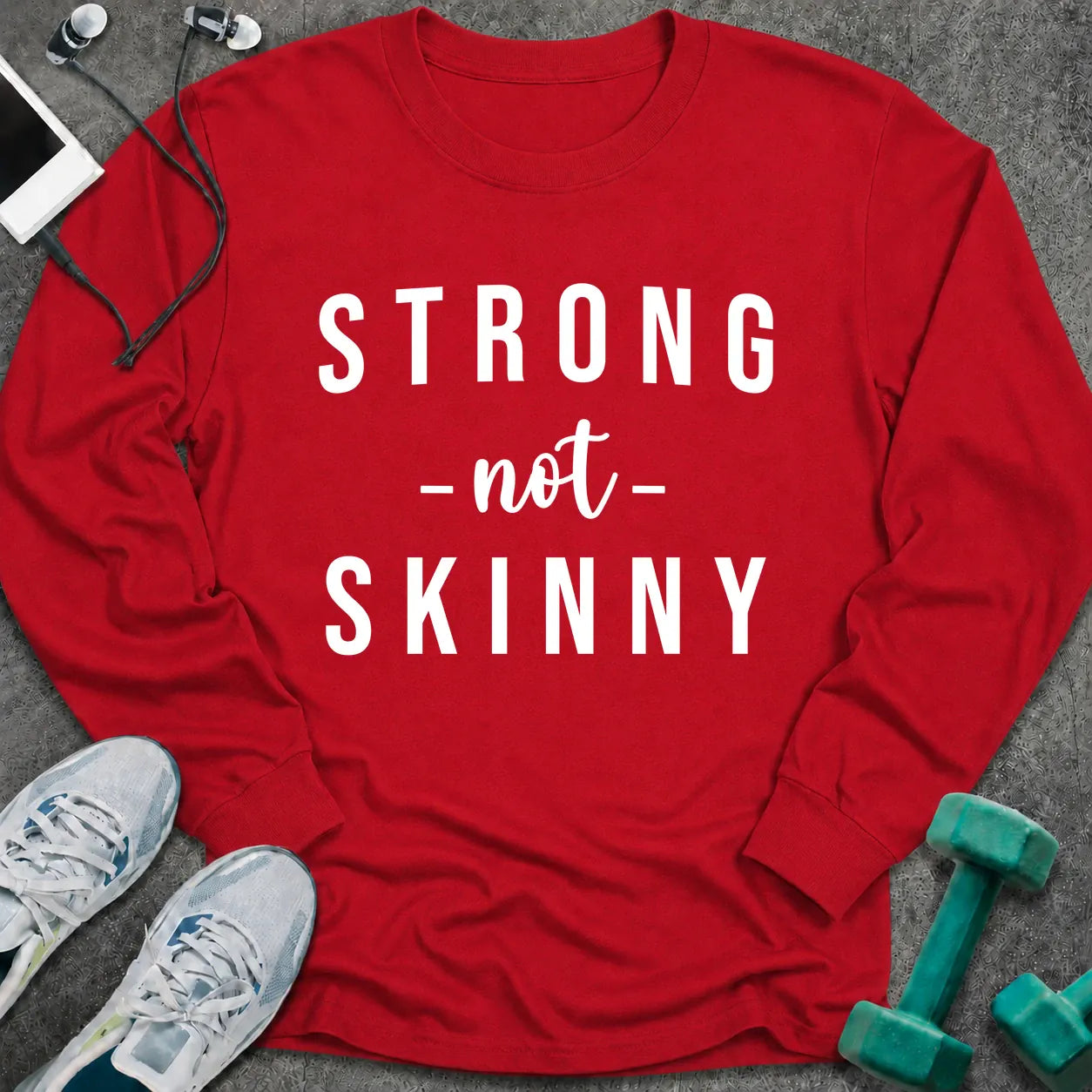 Red long sleeve tee printed with "Strong Not Skinny" in white