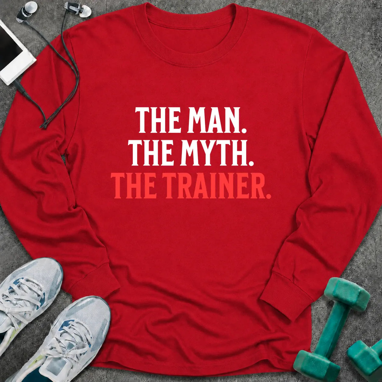 Red long sleeve tee printed with "The Man. The Myth. The Trainer." in white and coral