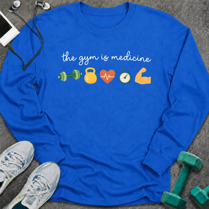 Royal long sleeve tee printed with "the gym is medicine" in white script, with dumbbell, kettlebell, heart, stopwatch and flexed arm icons