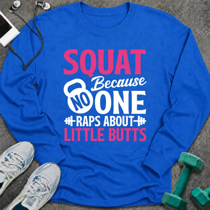 Royal long sleeve tee printed with "Squat Because No One Raps About Little Butts" in pink and white, with a kettlebell and dumbbells worked into the lettering