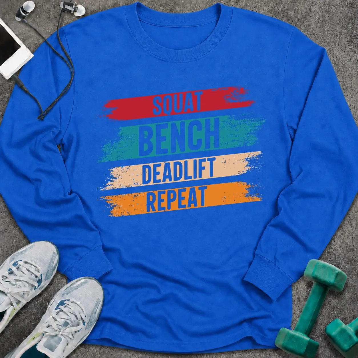 Royal long sleeve tee printed with "Squat Bench Deadlift Repeat" in white, with teal, cream and orange brush strokes behind each word