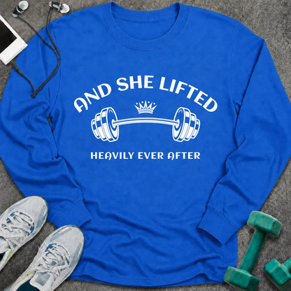 Royal long sleeve tee printed with "And She Lifted Heavily Ever After" in white, with a barbell topped with a crown
