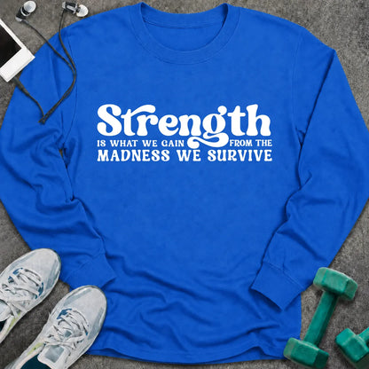 Royal long sleeve tee printed with "Strength Is What We Gain From The Madness We Survive" in white