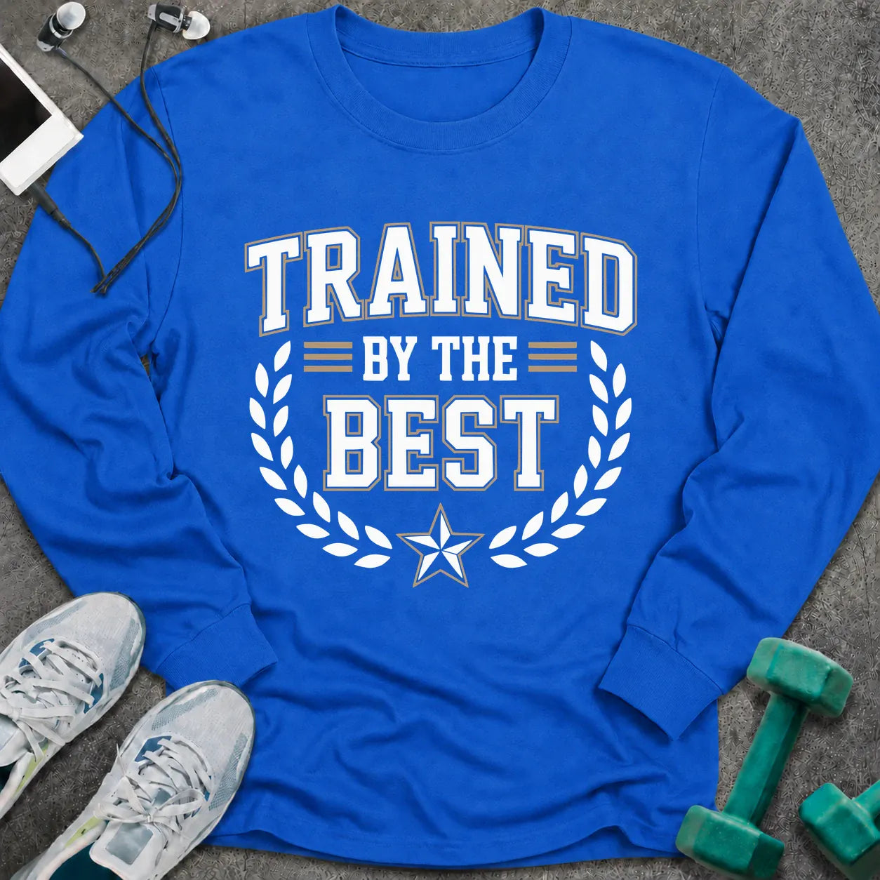 Royal long sleeve tee printed with "Trained By The Best" in white, with a laurel wreath and star
