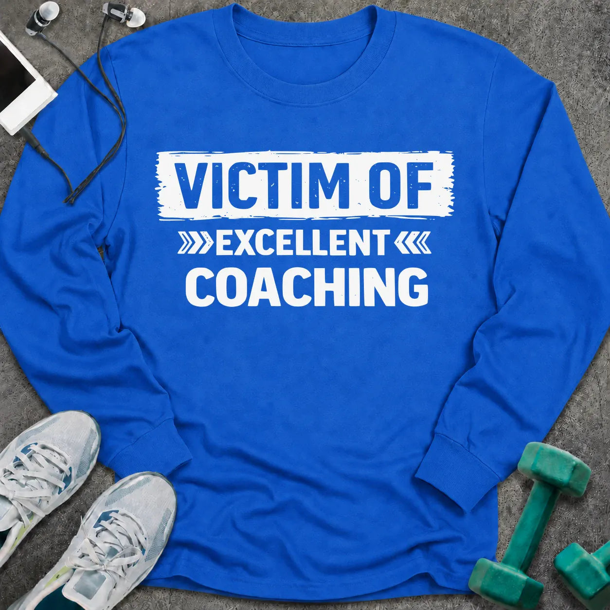 Royal long sleeve tee printed with "Victim Of Excellent Coaching" in white, with a painted brush stroke banner