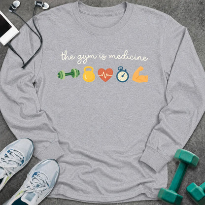 Sport grey long sleeve tee printed with "the gym is medicine" in white script, with dumbbell, kettlebell, heart, stopwatch and flexed arm icons