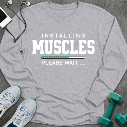 Sport grey long sleeve tee printed with "Installing Muscles Please Wait" in white, with a green loading bar