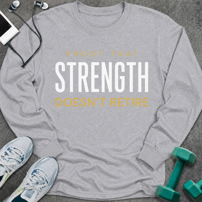 Sport grey long sleeve tee printed with "Proof That Strength Doesn't Retire" in white and gold