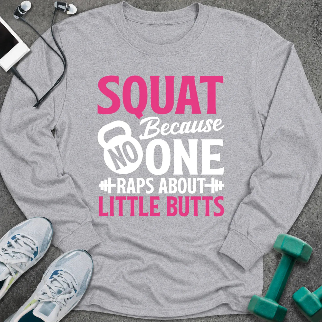 Sport grey long sleeve tee printed with "Squat Because No One Raps About Little Butts" in pink and white, with a kettlebell and dumbbells worked into the lettering