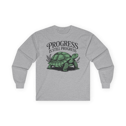Sport grey long sleeve tee printed with "Progress Is Still Progress" in black, with a tortoise