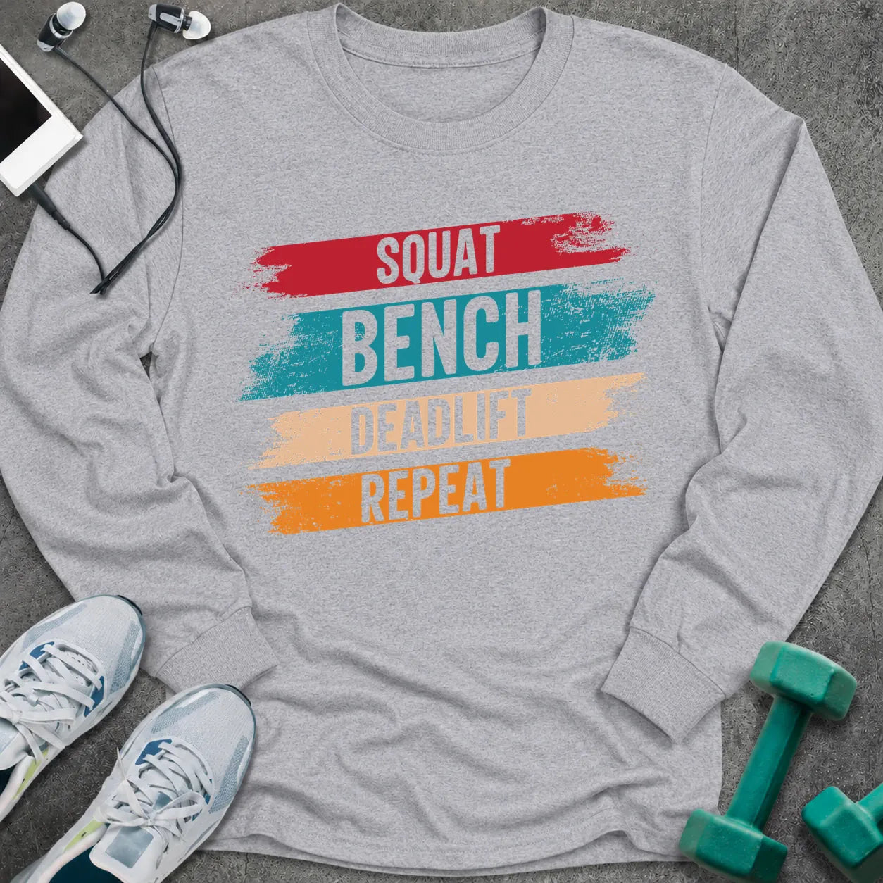 Sport grey long sleeve tee printed with "Squat Bench Deadlift Repeat" in white, with teal, cream and orange brush strokes behind each word