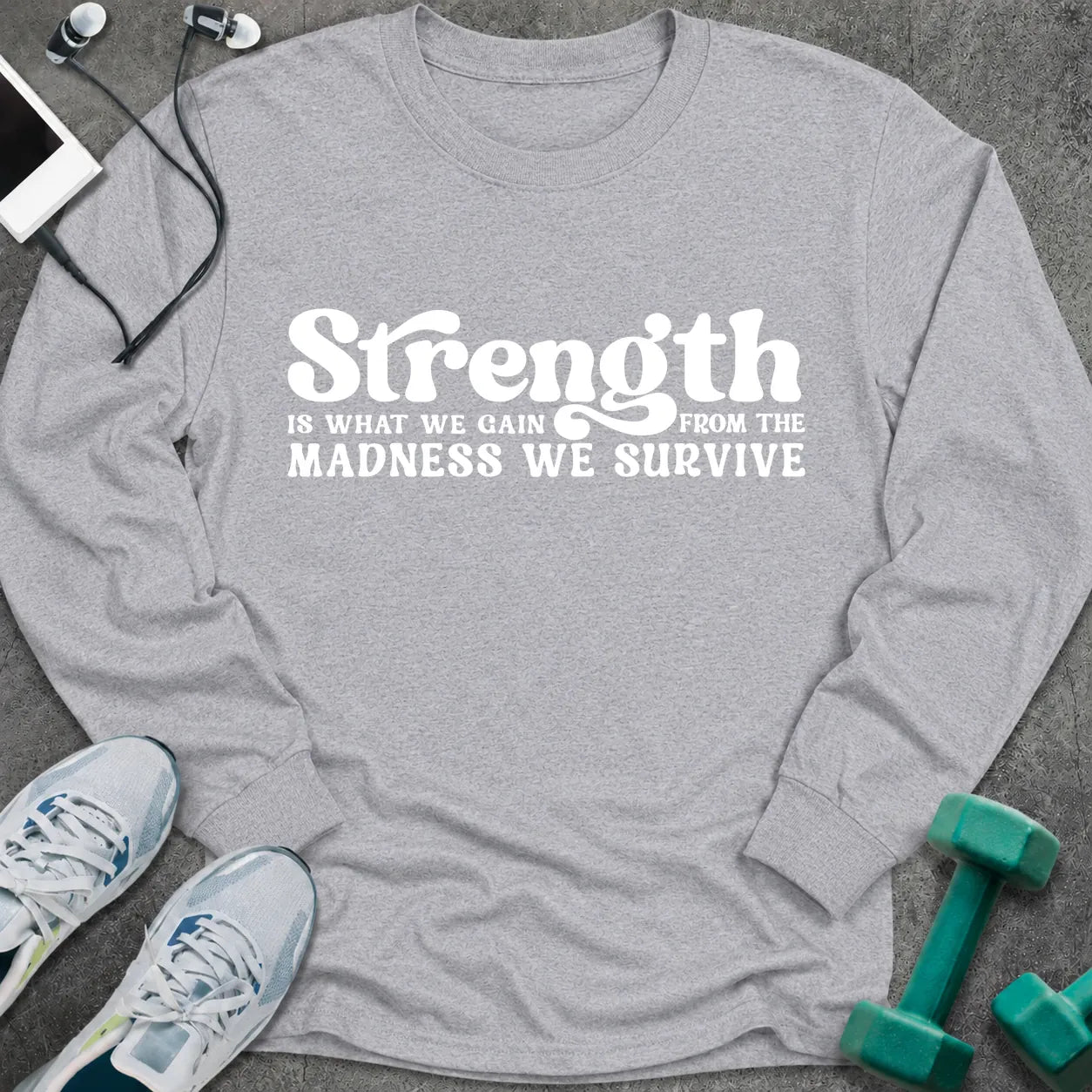 Sport grey long sleeve tee printed with "Strength Is What We Gain From The Madness We Survive" in white