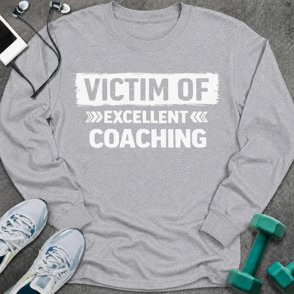 Sport grey long sleeve tee printed with "Victim Of Excellent Coaching" in white, with a painted brush stroke banner