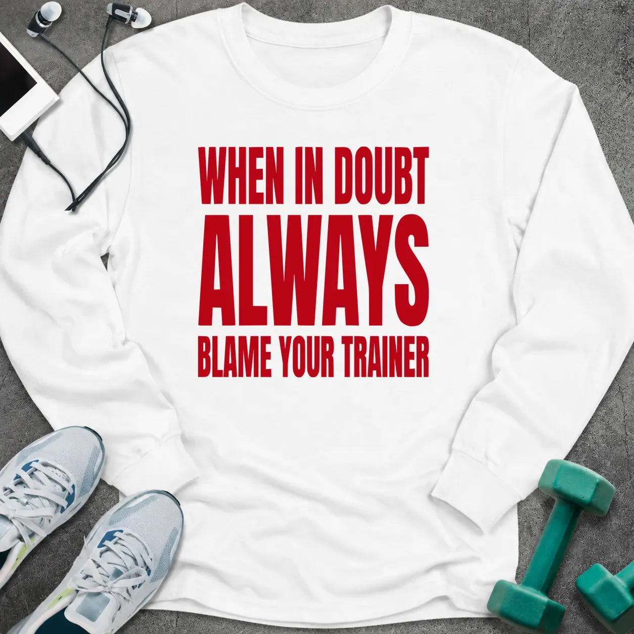 White long sleeve tee printed with "When In Doubt Always Blame Your Trainer" in red
