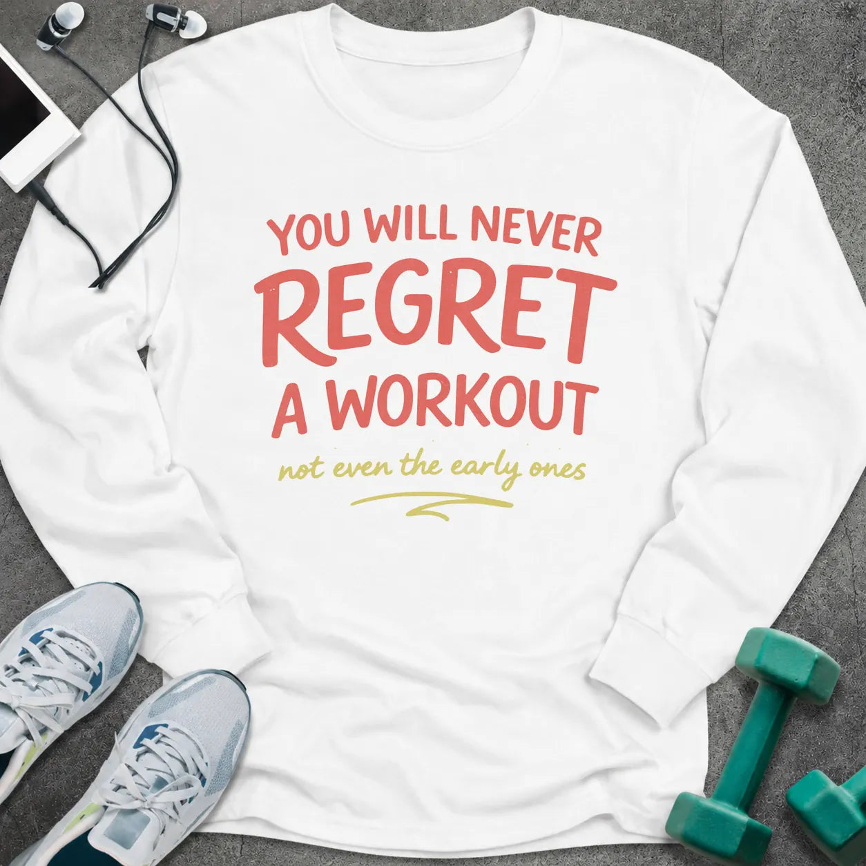 White long sleeve tee printed with "You Will Never Regret A Workout, not even the early ones" in coral and gold