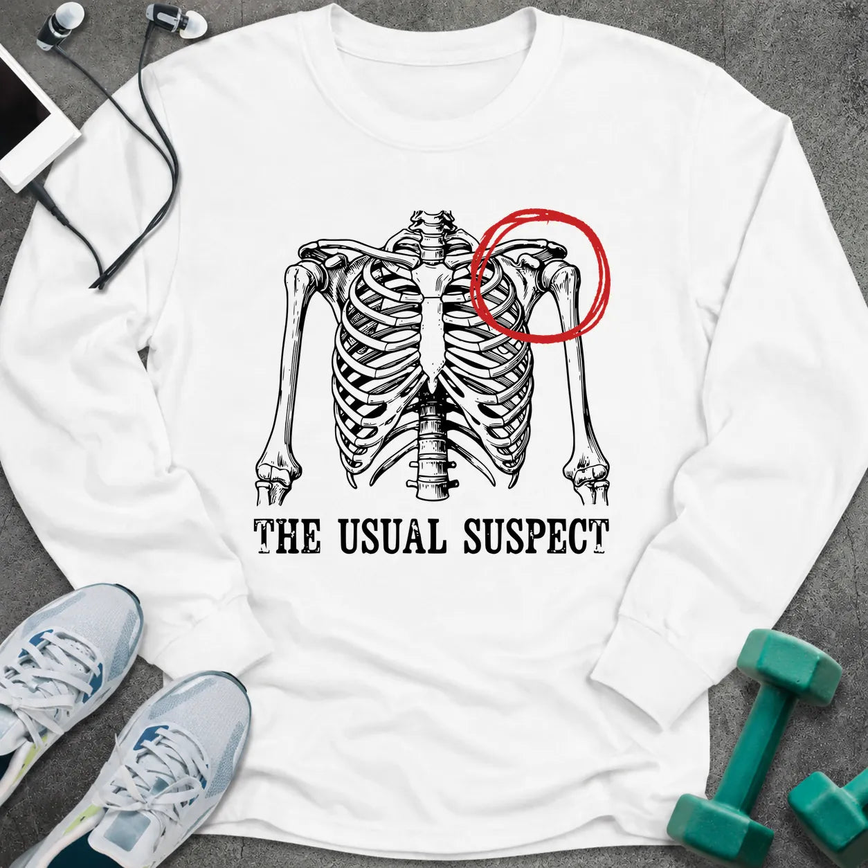 White long sleeve tee printed with "The Usual Suspect" in black, with a skeleton ribcage with one shoulder circled in red