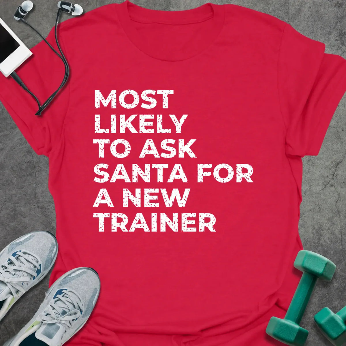 Cherry red t-shirt printed with "MOST LIKELY TO ASK SANTA FOR A NEW TRAINER" in white