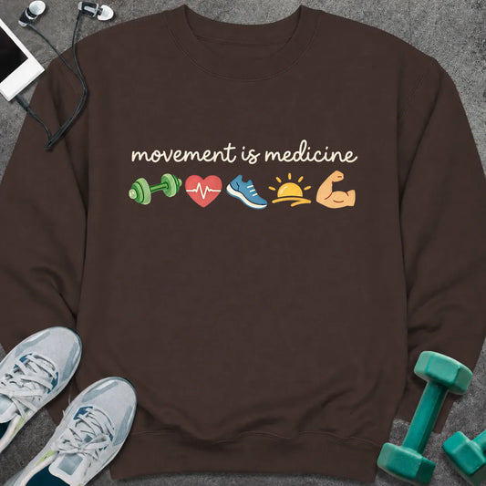 Chocolate brown sweatshirt printed with "movement is medicine", with small icons of a dumbbell, heart, sneaker, sunrise and flexed arm