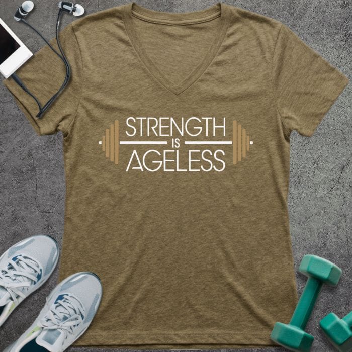 T-shirt printed with "Strength is Ageless" in white and gold, with barbell design elements