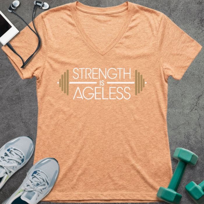 T-shirt printed with "Strength is Ageless" in white and gold, with barbell design elements