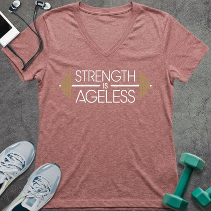 T-shirt printed with "Strength is Ageless" in white and gold, with barbell design elements