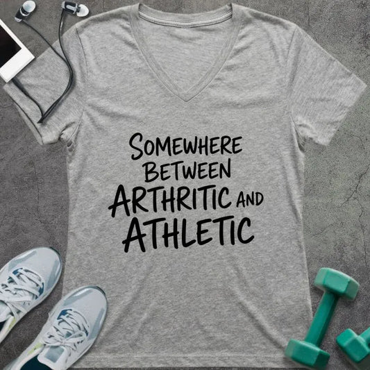 Athletic heather v-neck printed with "SOMEWHERE BETWEEN ARTHRITIC AND ATHLETIC" in black