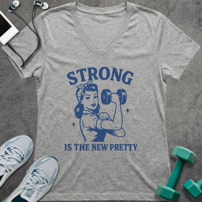 Athletic heather t-shirt printed with "Strong is the New Pretty" in blue, with a woman flexing in Rosie the Riveter style