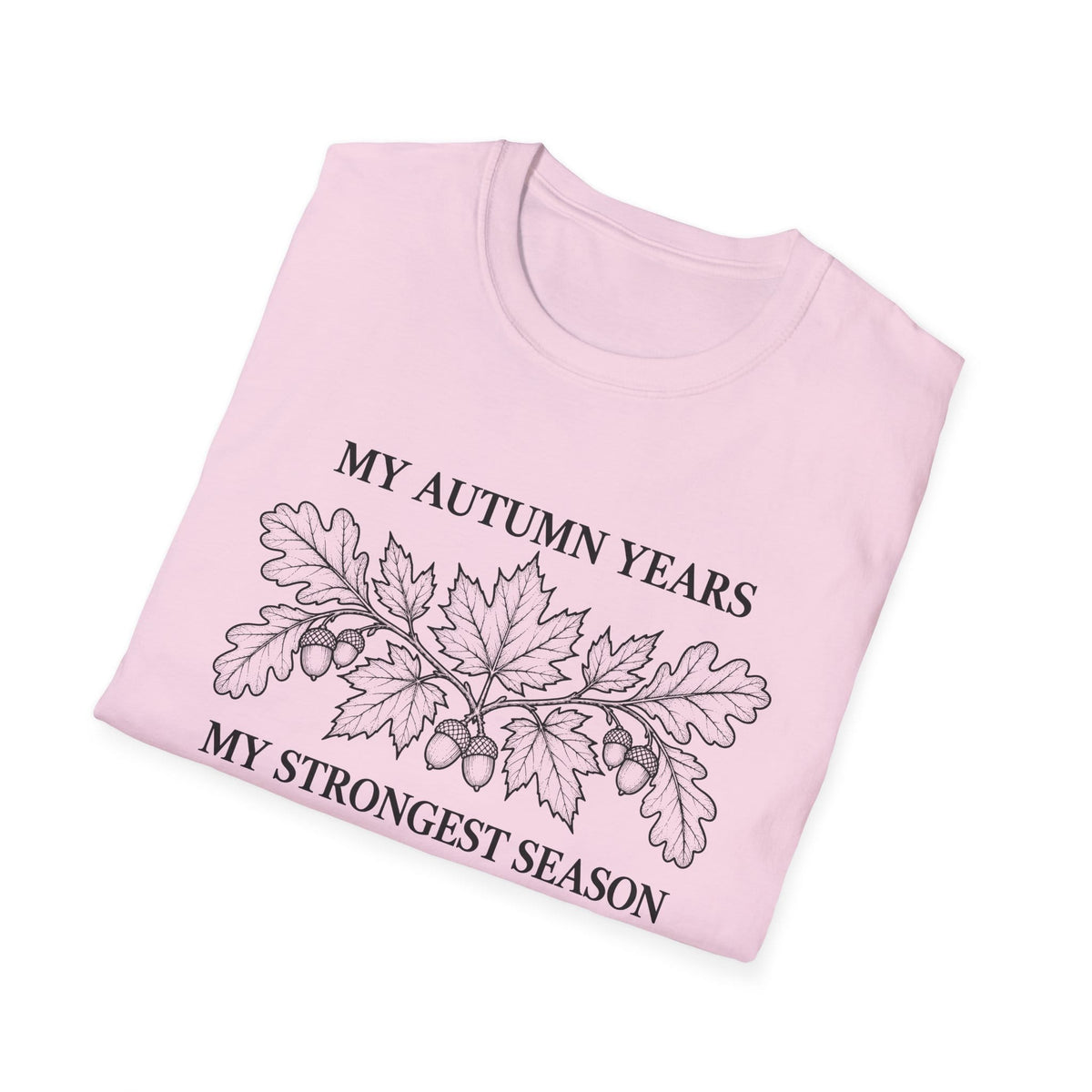 Folded light pink t-shirt printed with "MY AUTUMN YEARS, MY STRONGEST SEASON" in black, with oak leaves and acorns
