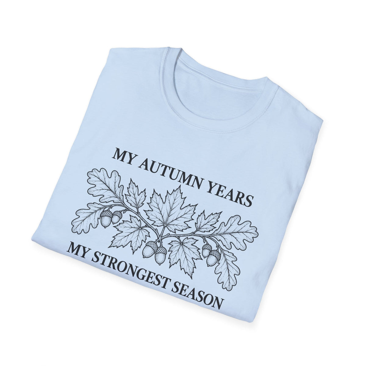 Folded light blue t-shirt printed with "MY AUTUMN YEARS, MY STRONGEST SEASON" in black, with oak leaves and acorns