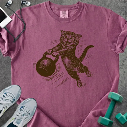 Berry t-shirt with an illustration of a cat swinging a kettlebell in brown and white