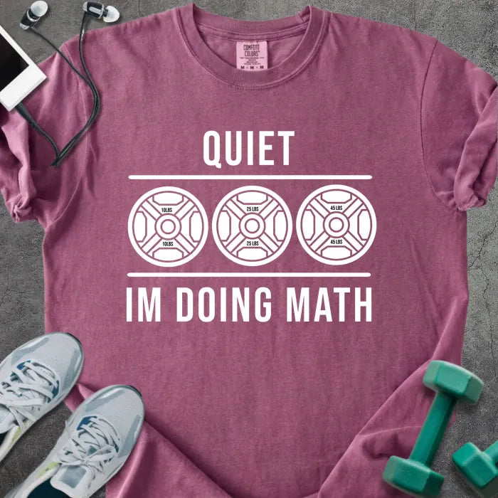 Berry t-shirt printed with "Quiet Im Doing Math" in white, with three weight plate graphics