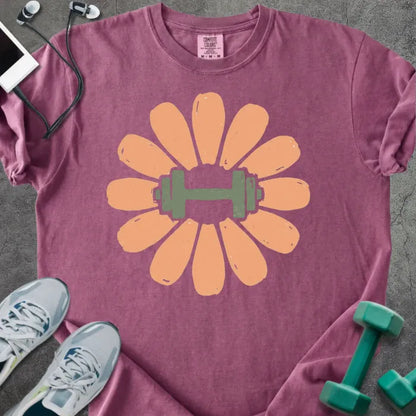 Berry t-shirt with coral/peach flower and dumbbell in center in peach and green