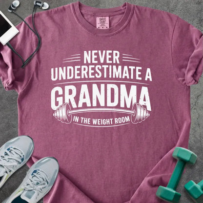 Berry t-shirt printed with "Never Underestimate a Grandma in the Weight Room" in white, with a barbell graphic