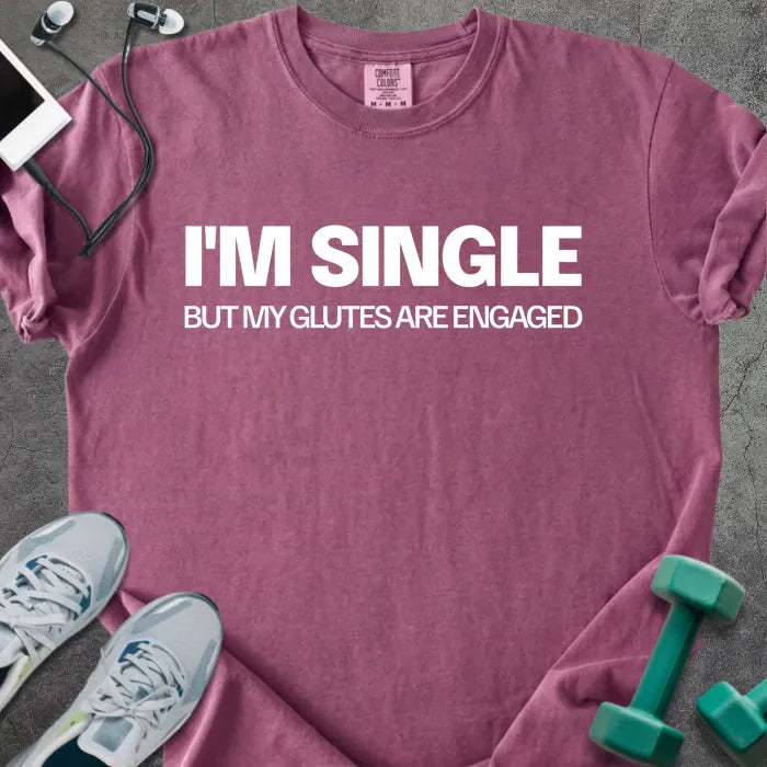 Berry t-shirt printed with "I'm Single but my Glutes Are Engaged" in white