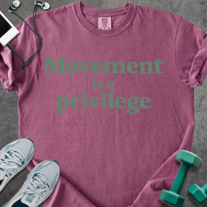 Berry t-shirt printed with "Movement is a privilege" in teal
