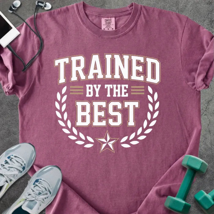Berry t-shirt printed with "Trained By the Best" in tan and white, with laurel wreath and star