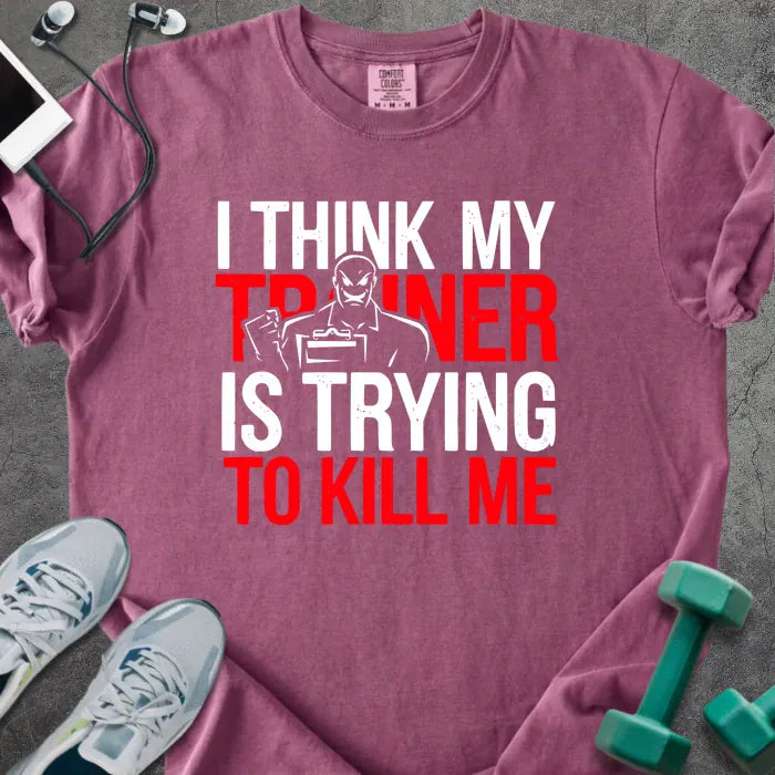Berry t-shirt printed with "I Think my Trainer is Trying to Kill Me" in red and white, with a trainer figure