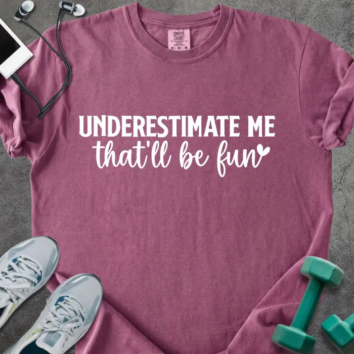 Berry t-shirt printed with "UNDERESTIMATE ME that'll be fun" in white