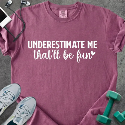 Berry t-shirt printed with "UNDERESTIMATE ME that'll be fun" in white