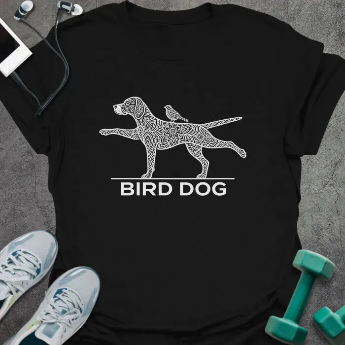 Black t-shirt printed with "BIRD DOG" in white, with a patterned dog in the bird dog exercise pose and a small bird on its back
