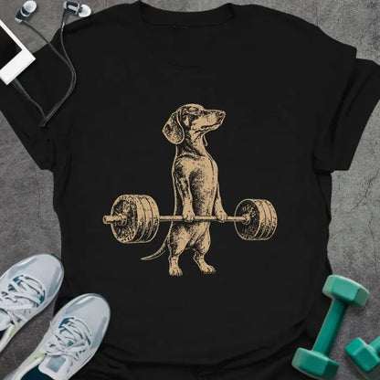 Black t-shirt with an illustration of a Dachshund holding a barbell in white