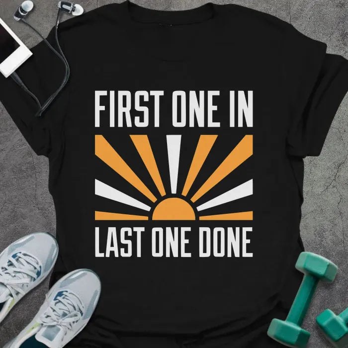 Black t-shirt printed with "First One in Last One Done" in orange and white, with sun graphic