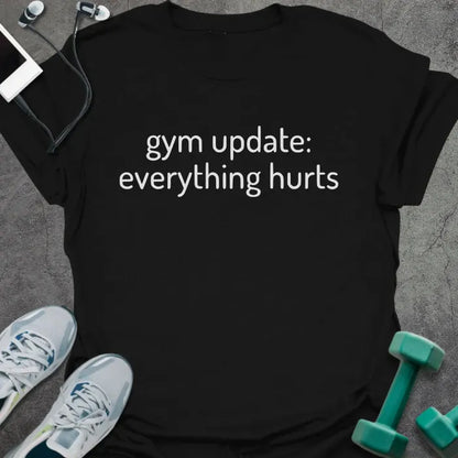 Black t-shirt printed with "gym update: everything hurts"