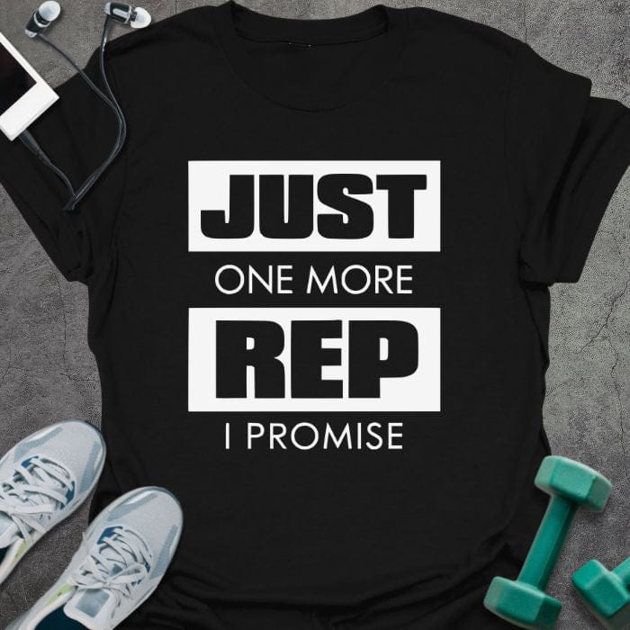 Black t-shirt printed with "Just One More Rep I Promise" in white and green, with a kettlebell and dumbbell