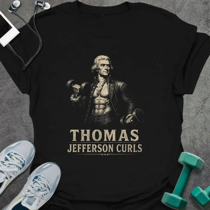 Black t-shirt printed with "Thomas Jefferson Curls", with an illustration of Thomas Jefferson with an exposed muscular torso doing dumbbell curls