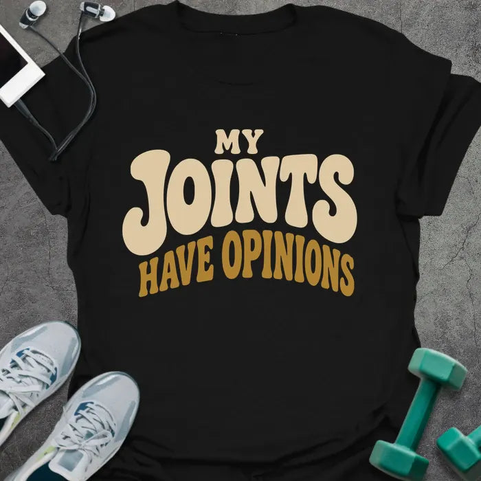 Black t-shirt printed with "My Joints Have Opinions" in tan and gold