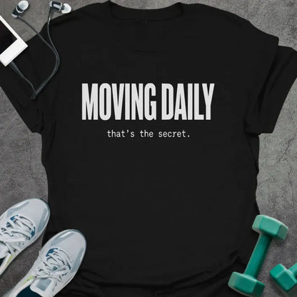 Black t-shirt printed with "MOVING DAILY that's the secret." in white