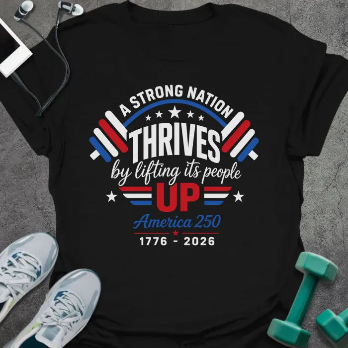 Black t-shirt printed with "A STRONG NATION THRIVES by lifting its people UP" in red and white, with barbells and stars in American flag style