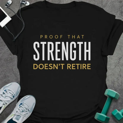 Black t-shirt printed with "Proof That Strength Doesn't Retire" in white and gold