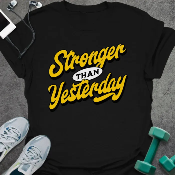 Black t-shirt printed with "Stronger THAN Yesterday" in yellow